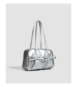 Close-up detail view of the silver metallic bowling bag showcasing front bow pockets.