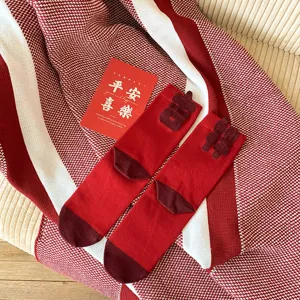 Festive red mid-tube cotton socks for women, winter hosiery with flocked Chinese characters, cozy.