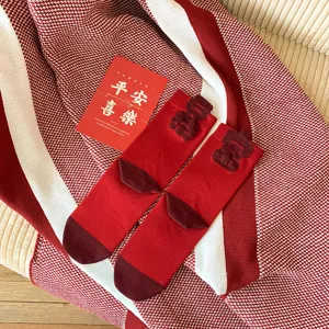 Red cotton mid-calf socks detail, flocked character design, festive style, comfortable wear.