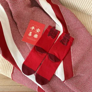Red mid-tube socks for women, comfortable cotton knit fabric with festive flocked details.
