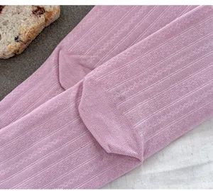 Close-up detail of cozy pink split-toe socks with fine ribbed texture for daily wear.