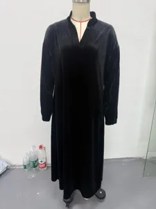 Detail view of the black velvet long sleeve V-neck dress, showcasing the loose silhouette.