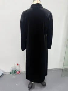 Back view of a black velvet maxi dress featuring long sleeves and a stand collar, loose fit.