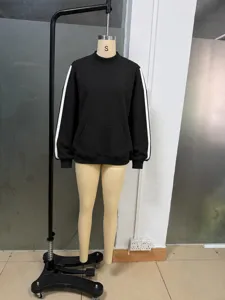 Black high-neck ribbed sweatshirt with white side stripes, loose casual athletic style.