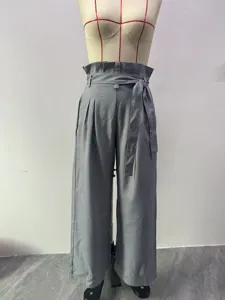Grey high waist wide leg trousers detail, featuring paper bag waist and tie belt design.