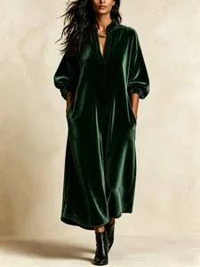Elegant dark green velvet midi dress with V-neck, lantern sleeves and relaxed fit style.