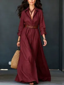 Burgundy long sleeve maxi shirt dress detail, belted waist, elegant flowing hemline and collar.