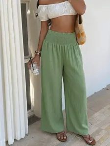 Green high-waisted smocked wide leg pants, casual resort wear trousers for women summer style.