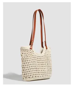 Detailed view of the woven hollow crochet texture and durable brown PU leather shoulder straps.