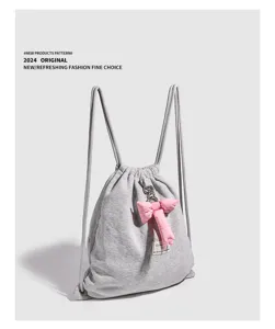 Sac à dos minimaliste en tissu gris avec joli nœud rose pour femmes pour un usage quotidien