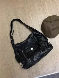 Black soft leather slouchy shoulder bag with multi-pocket design and adjustable strap for daily use.