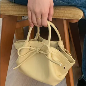 Sac à main seau en cuir PU jaune pour femme avec nœud élégant, sac cabas tendance et chic.