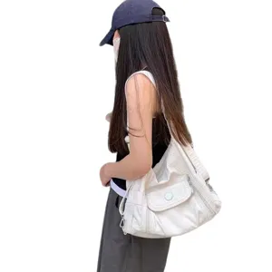 White soft leather motorcycle shoulder bag Y2K retro hobo tote with multiple zipper pockets.