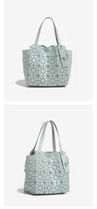 Light blue geometric tote bag detail showing unique triangle panels and dual shoulder handles.