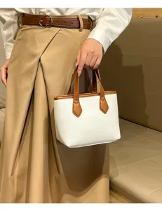 Chic white litchi pattern bucket handbag with brown handles, perfect for daily commuting.