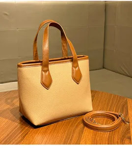 Chic commuter litchi grain bucket handbag with top handles and strap for versatile daily wear.