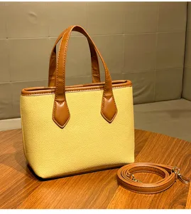 Stylish women's leather bucket handbag with top handle and detachable strap for daily commute.