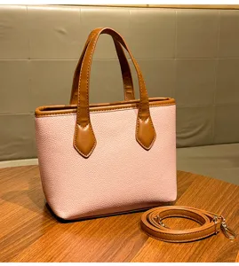 Pink and brown textured handbag detail, litchi grain bucket bag with dual handles and strap