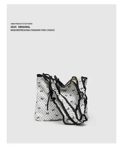 White canvas shoulder bag with black polka dots, sweet bow pattern and ruffled trim style.