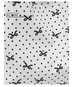 Detailed view of sweet bow and polka dot canvas bag fabric, trendy daily student handbag.