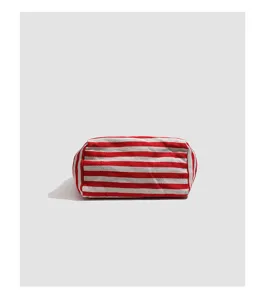 Detail shot of the red and white striped canvas pouch, showing clear fabric texture and clean stitching.