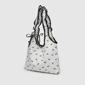 White polka dot canvas shoulder bag with ruffled straps and cute bow design for daily use.