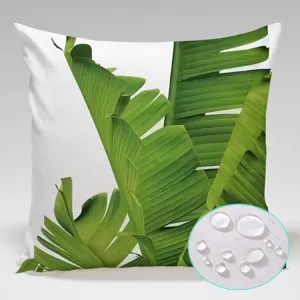Close-up detail of waterproof outdoor pillow cover featuring vibrant tropical banana leaf print.