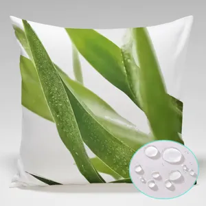 Waterproof pillowcase detail showing green leaf print and fabric waterproof droplet test close-up.