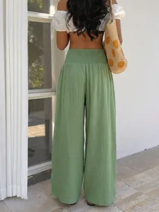 Detailed back view of women's green casual high-waist wide-leg trousers in resort vacation style.