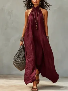 Detail view of boho halter maxi dress in wine red, worn with striped bag and chic accessories.