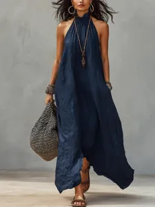 Dark blue halter maxi dress detail, showing soft wrinkle texture and elegant backless cut.