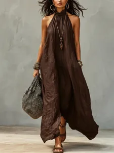 Detailed view of the brown halter neck maxi dress with wrinkled fabric and flowing bohemian style.