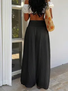 Detail shot of women's high waist loose wide leg resort pants with textured fabric.