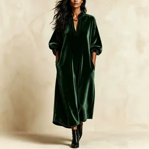 Elegant dark green velvet loose long dress featuring a V-neck and chic lantern sleeves.