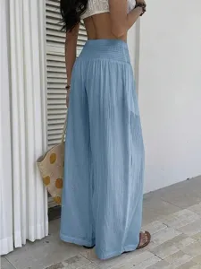 Detail view of light blue resort-style high-waist wide-leg pants, breathable fabric.