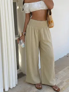 Detail view of casual resort wide-leg pants featuring high pleated elastic waist design.