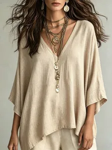 Detail shot of the beige V-neck linen top, showcasing the casual loose fit and 3/4 sleeves.