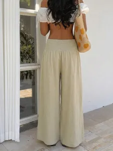 Detail view of loose resort style casual wide-leg pants in light beige, breathable fabric.