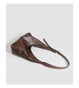 Retro brown soft leather hobo shoulder bag detail, showcasing smooth texture and metal buckle.