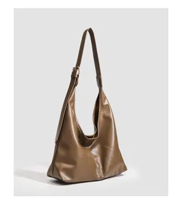 Brown soft leather shoulder bag detail, stylish hobo daily commuting purse close-up view.