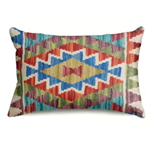 Close-up of bohemian geometric pattern throw pillow cover, vibrant colorful tribal design.