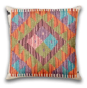 Close-up detail of bohemian kilim geometric pattern cushion cover with vibrant colors.