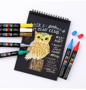Colorful oil-based paint markers set with black sketchpad for DIY art and graffiti.