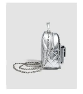 Silver quilted mini backpack detail showing chain strap, metallic finish and zipper pocket.