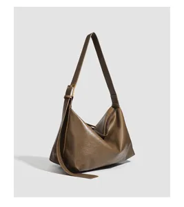 Brown slouchy shoulder bag detail, large capacity hobo bag close-up view, minimalist style.