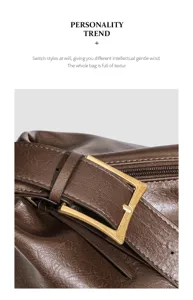Detail view of brown leather tote bag buckle, stylish commuting large capacity autumn bag.