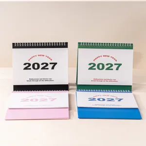 Desktop calendar detail showing colorful 2027 yearly planners with metal binding design.