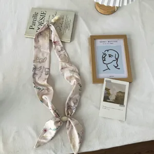 Ins style pink twilly silk scarf with creative doodle prints and chic magnetic charm detail.