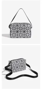 Detailed view of silver geometric lattice crossbody bag, stylish folding design details.