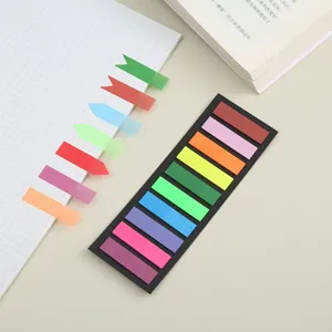 Translucent colorful sticky notes and index tabs displayed on grid notebook and desk detail view.